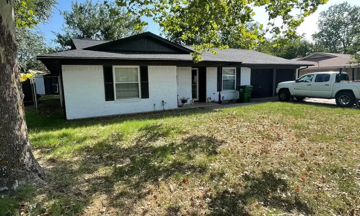 Professional roofing crew working on a residential roof in Solvay